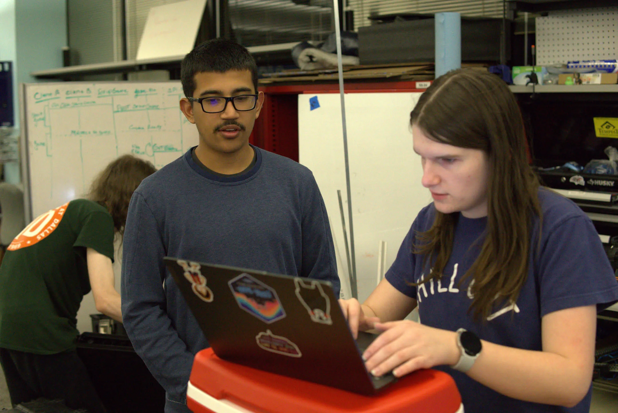 Natalie teaching a member 3D Printing