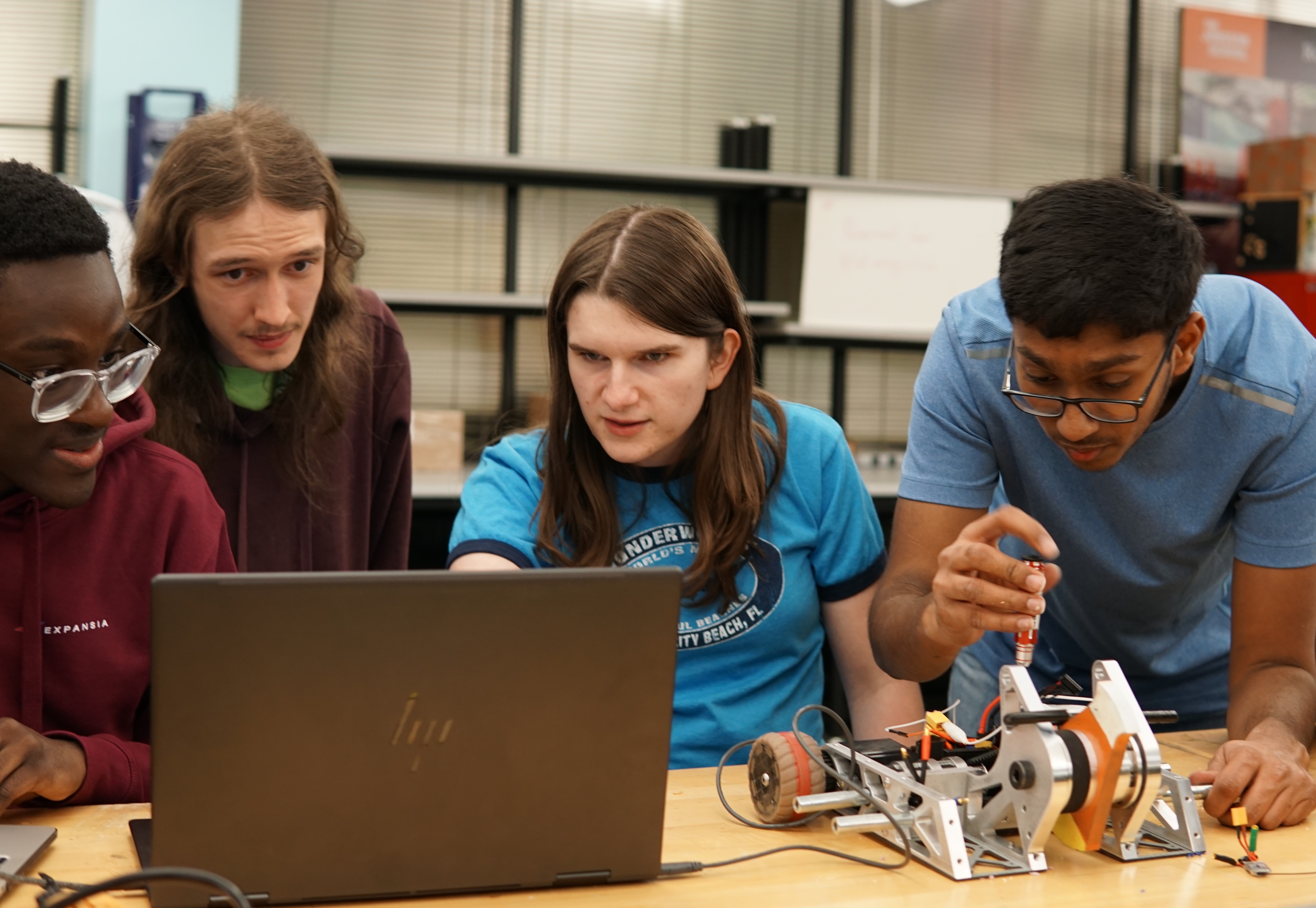 Natalie Stromberg working on a robot with colleagues