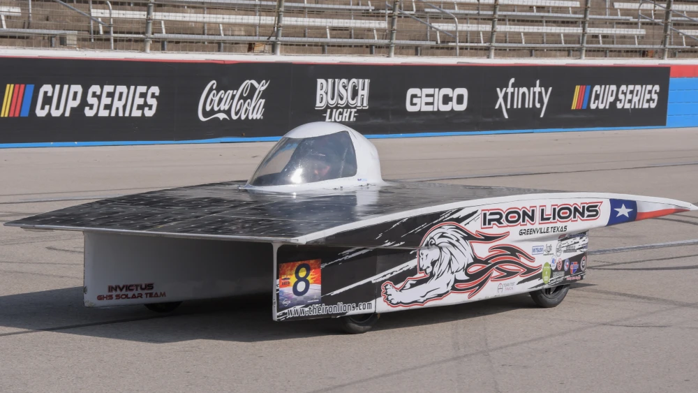 Solar car driving on a racetrack